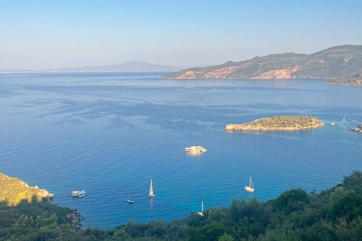 The bay below the house, with the islet off Kalamitsi and boats at anchor.