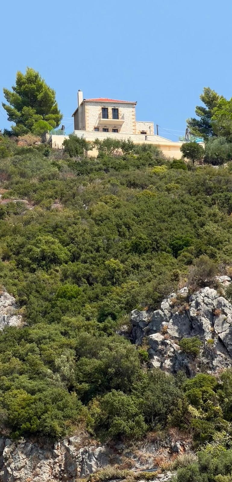 The house on its hillside above Kalamitsi, among the olives and the scrub.
