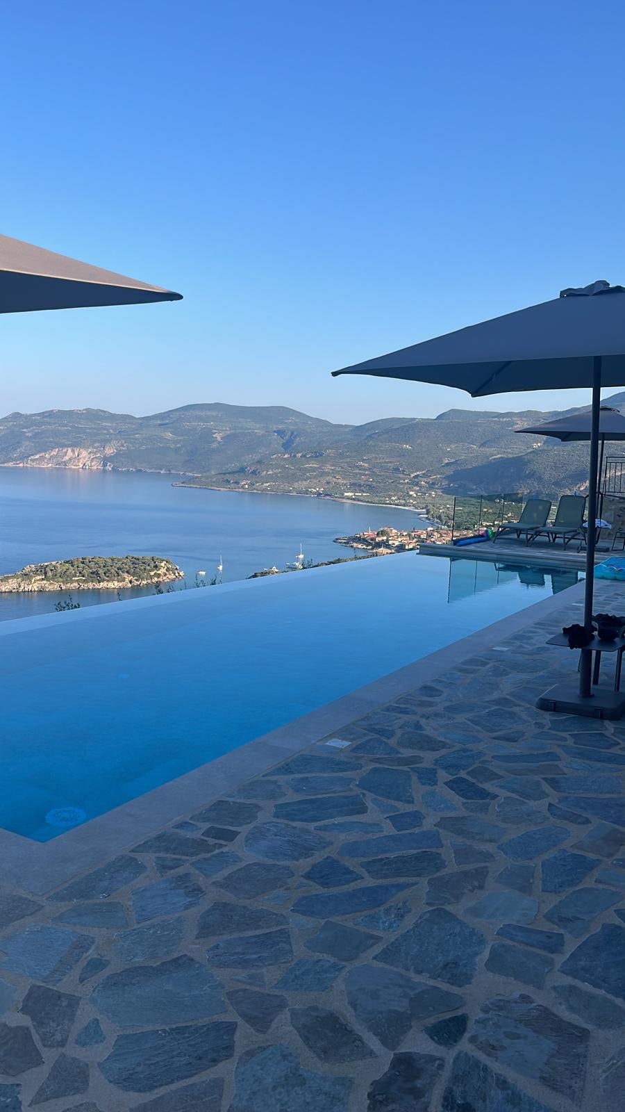 Parasols on the terrace, Kardamyli along the shore in the distance.